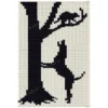 Hunting Dog Loom Knit Blanket Pattern - a black coonhound standing on its hind legs against a tall bare tree, head raised baying at a raccoon in the branches above, worked in stockinette colorwork with 2 colors: Ivory and Black.