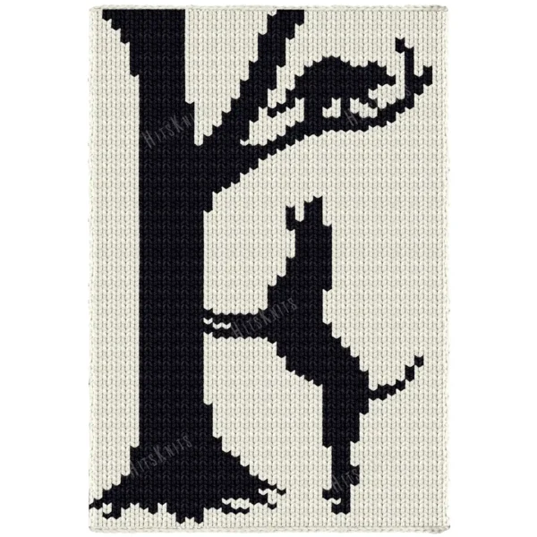 Hunting Dog Loom Knit Blanket Pattern - a black coonhound standing on its hind legs against a tall bare tree, head raised baying at a raccoon in the branches above, worked in stockinette colorwork with 2 colors: Ivory and Black.
