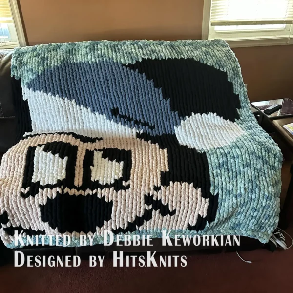 Christmas Mickey Finger Knit Blanket Pattern - Mickey Mouse in a red Santa hat with a white pompom on a lime background, knitted in stockinette colorwork intarsia with 5 colors: Lime, Black, Powder, White, Red.