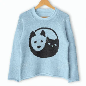 Cat and Dog Yin Yang Sweater Knitting Pattern showing a soft blue women's pullover with a black and blue yin yang motif of a cat and a dog on the front, knitted in worsted weight yarn, sizes S to 2XL.