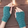 Checker Fingerless Gloves Knitting Pattern showing a pair of teal fingerless gloves with a checkerboard texture of garter and rib blocks and a thumb opening, worked in DK wool blend yarn, sizes S/M to L/XL.