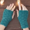 Checker Fingerless Gloves Knitting Pattern showing a pair of teal fingerless gloves with a checkerboard texture of garter and rib blocks and a thumb opening, worked in DK wool blend yarn, sizes S/M to L/XL.